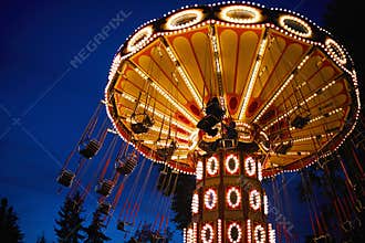 Carousel Merry-go-round in amusement park at a night city