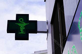 Green cross Pharmacy sign in street