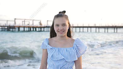 Portrait of teenage girl in braces against the evening sea.
