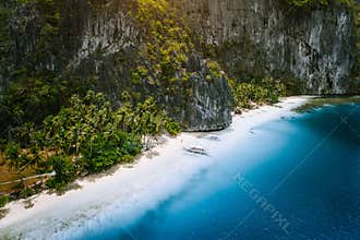 Aerial drone view of tropical exotic beach of Pinagbuyutan Island in El Nido. Amazing white sand beach and blue lagoon