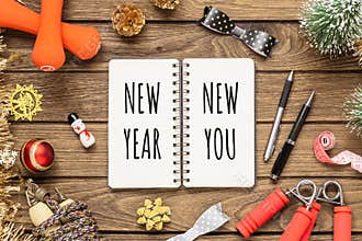 New year resolutions or goals for healthy lifestyle, lose weight and join gym concept. New Year New You written in notebook with