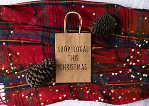 Shop Local This Christmas text on a plain brown paper bag flat la