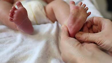 Newborn reflexes. Infant bends toes in response to foot pressure.