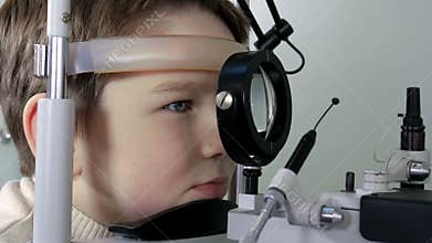 Optometrist performing visual field test of young boy