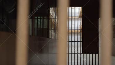 View of the prison corridor through the bars.
