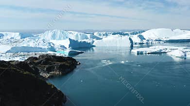 Global Warming and Climate Change - Giant Iceberg from melting glacier in Ilulissat, Greenland. Aerial drone of arctic