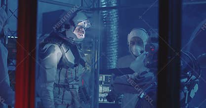 Astronauts testing spacesuit in laboratory