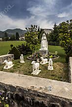 Statue of Bernadette of Lourdes with sheep in Lourdes