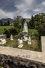 Statue of Bernadette of Lourdes with sheep in Lourdes