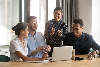 Happy diverse office workers team laugh work together at meeting