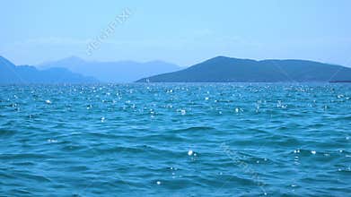 Sea water with soft waves at summer noon