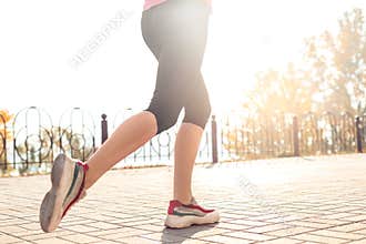 Healthy Lifestyle. Young woman jogging outdoors autumn season feet close-up