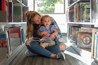 Barrington, IL/USA - 09-23-2019: Stylish young mom and toddler girl at the public library
