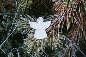 Wooden decoration angel white figure in spruce branches