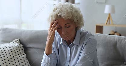 Depressed worried old woman feeling headache or mental stress concept