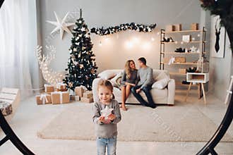 Lovely girl with present against her parents.