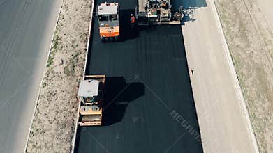 Top view of an asphalt road getting done by the workers