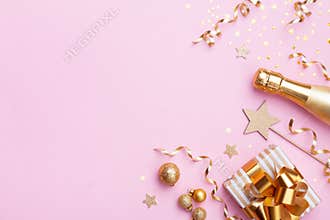 Christmas or New year festive background. Champagne bottle, gift or present box and golden confetti on pink top view. Flat lay