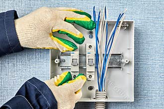 Electrician installs a household electrical panel