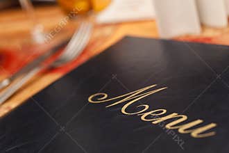 Menu & Cutlery on A Restaurant Table
