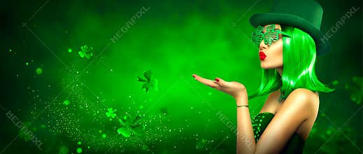 St. Patrick`s Day leprechaun laughing model girl pointing hand, holding product on green magic background