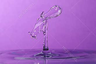 Abstract purple water drop collision