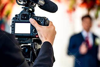 Female Videographer in backside are shooing and recording video in Wedding Event