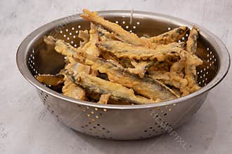 Deep fried little fish on gray background
