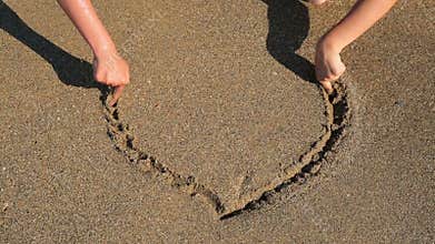 The wave washes away the drawing on the sand