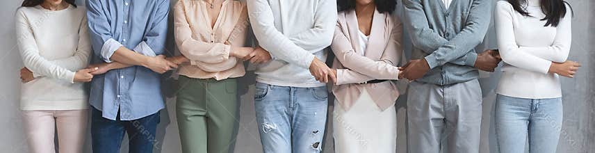 Close up of business team holding each other crossed hands