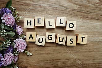 Hello August alphabet letters on wooden background
