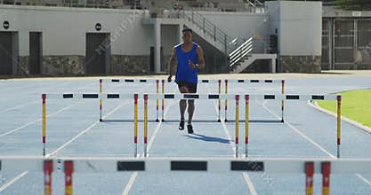 Front view of african american athlete doing hurdling