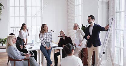 Skilled businessman coach training team at group seminar