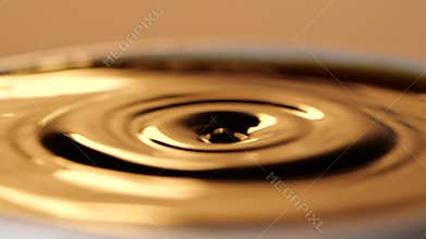 Espresso coffee drop into the filled Cup from the coffee machine in slow motion