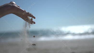 Close up shot on close man hand at the beach, holding beach sand and open slowly