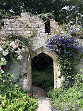 Old ruin turned into a secret garden with arched doorway