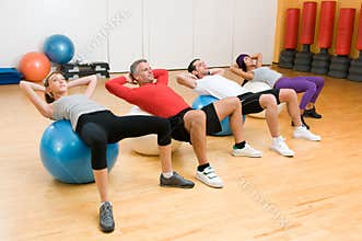 Exercising with fitness ball at gym