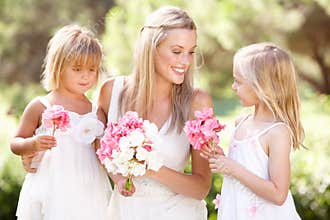 Bride With Bridesmaids Outdoors At Wedding