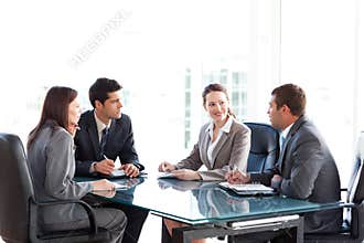 Businessmen and businesswomen talking at a table