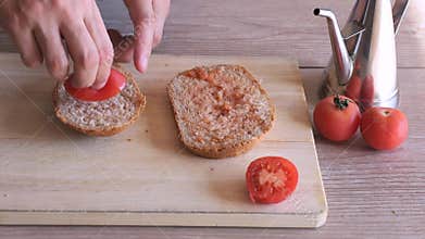 Man preparing traditional catalan recipe of bread with tomato