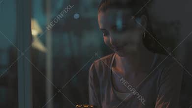 Happy girl social networking with her phone at night