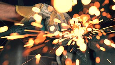 Blacksmith using an angle grinder in the workshop