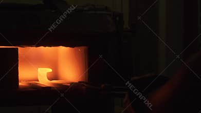Blacksmith forging iron in his workshop