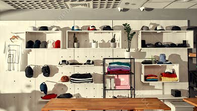 Superb quality, remarkable pricing. Custom apparel, clothes neatly arranged or folded on shelves. Stack of colorful