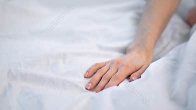 Close up seductive female hand touching soft white sheet. Shot on RED Raven 4k Cinema Camera