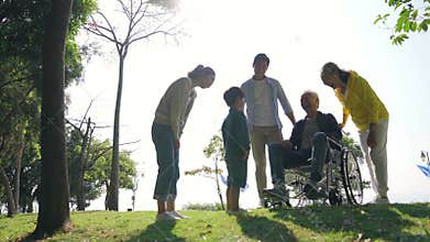 Three generation asian family enjoying outdoor activity in park