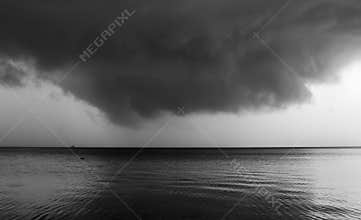 Black and white storm clouds and sea composition