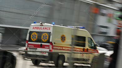 Ambulance white medical van with loud siren and blue flashing lights on rushes