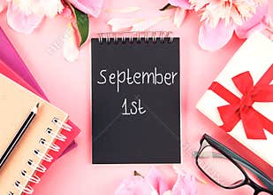 September 1st.Knowledge day.Back to school banner.School supplies and flowers top view