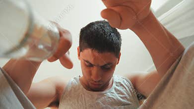 Guy with bruised eye in an alcoholic intoxication drinks vodka directly from bottle. problem alcohol addiction. Withdrawal pains